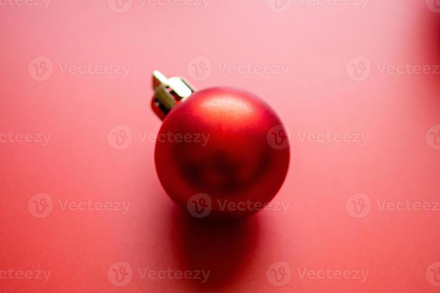 Christmas ball bauble on red background top view photo