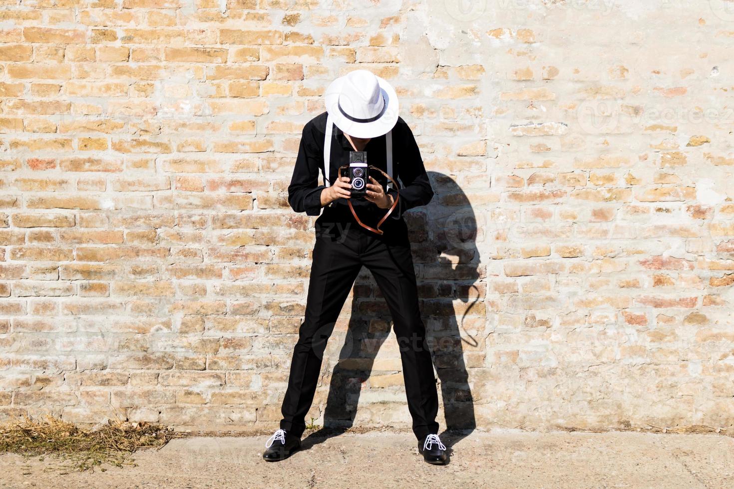 Unrecognizable photographer taking picture with medium format camera. photo