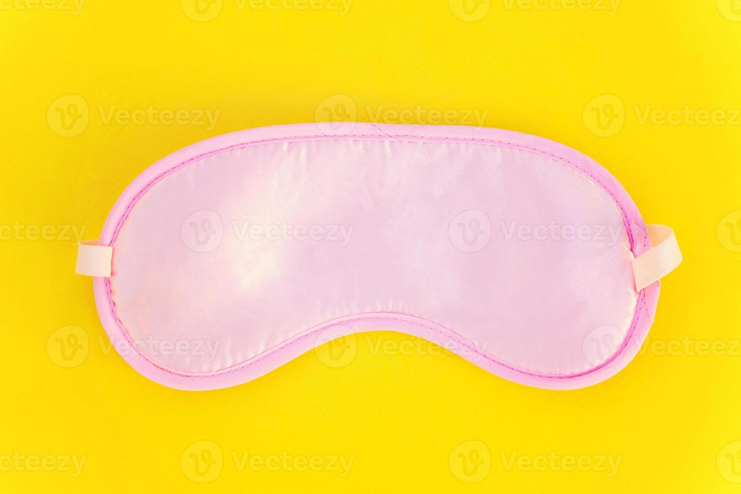 Sleeping mask on yellow background photo