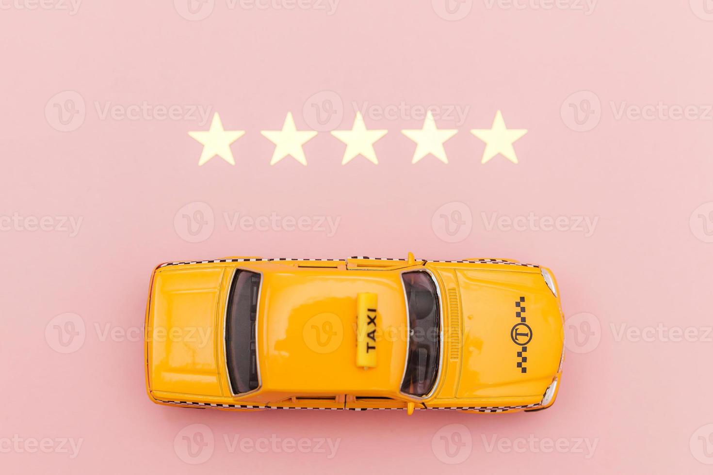 Yellow toy car Taxi Cab and 5 stars rating isolated on pink background. Smartphone application of taxi service for online searching calling and booking cab concept. Taxi symbol. Copy space. photo