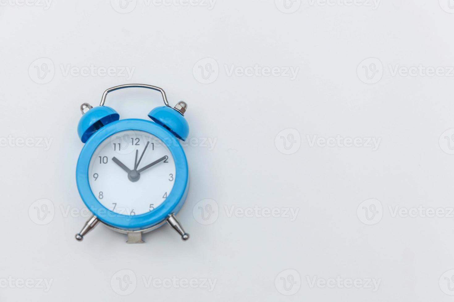 Simply flat lay design Ringing twin bell vintage classic alarm clock Isolated on white background. Rest hours time of life good morning night wake up awake concept. Flat lay top view copy space. photo