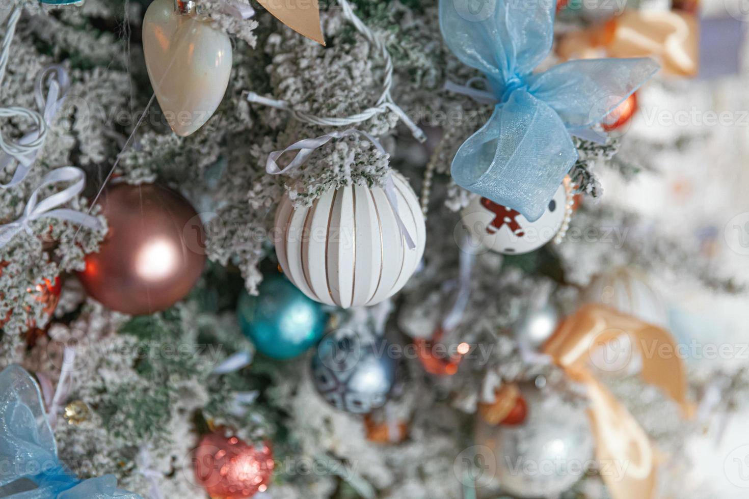 Classic Christmas New Year decorated New year tree with silver and white ornament decorations toy and ball. Modern classical style interior design apartment. Christmas eve at home. photo