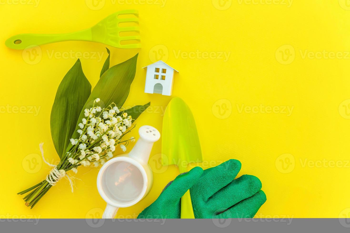 Flat Lay with gardening tools on yellow background photo