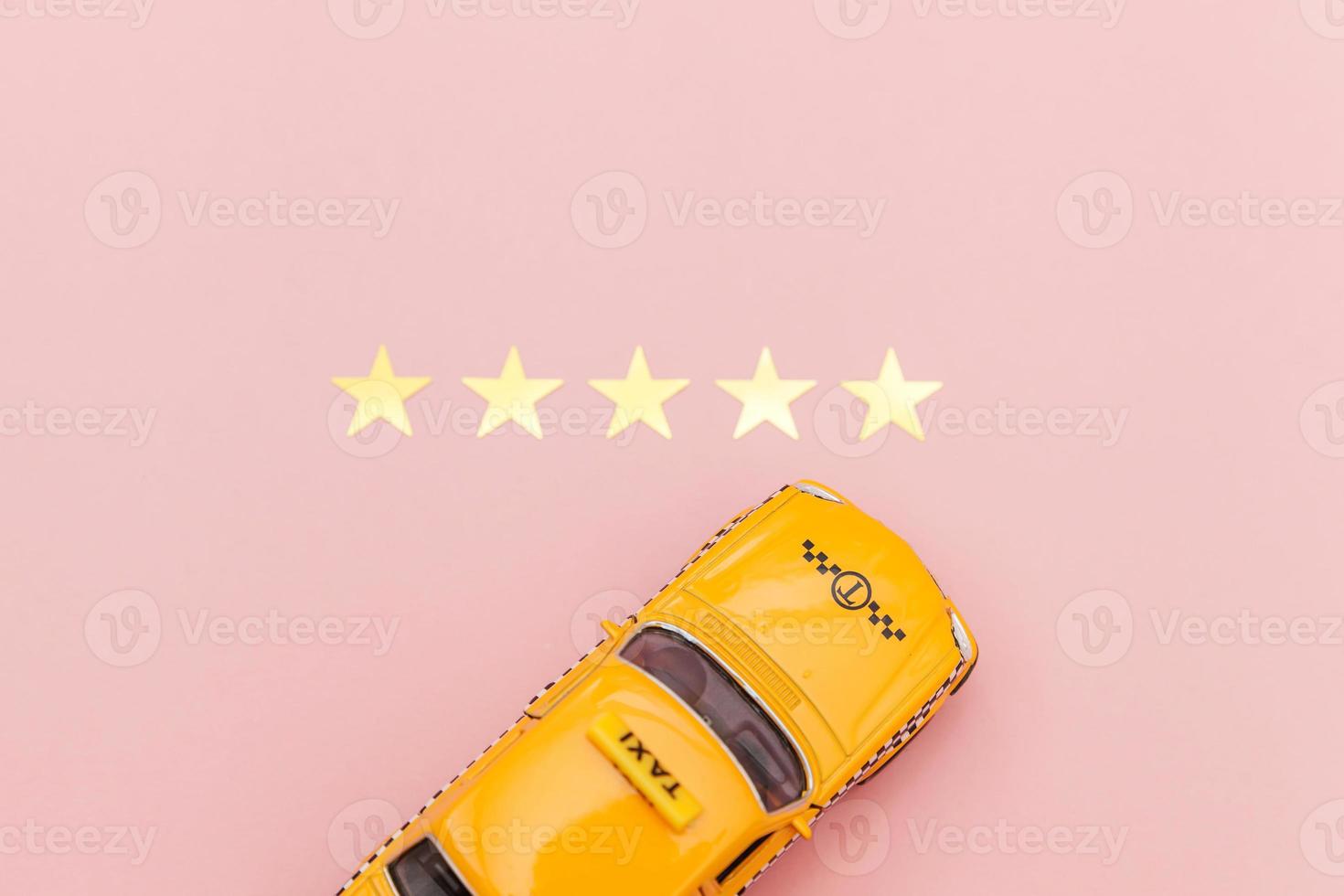 Yellow toy car Taxi Cab and 5 stars rating isolated on pink background. Smartphone application of taxi service for online searching calling and booking cab concept. Taxi symbol. Copy space. photo