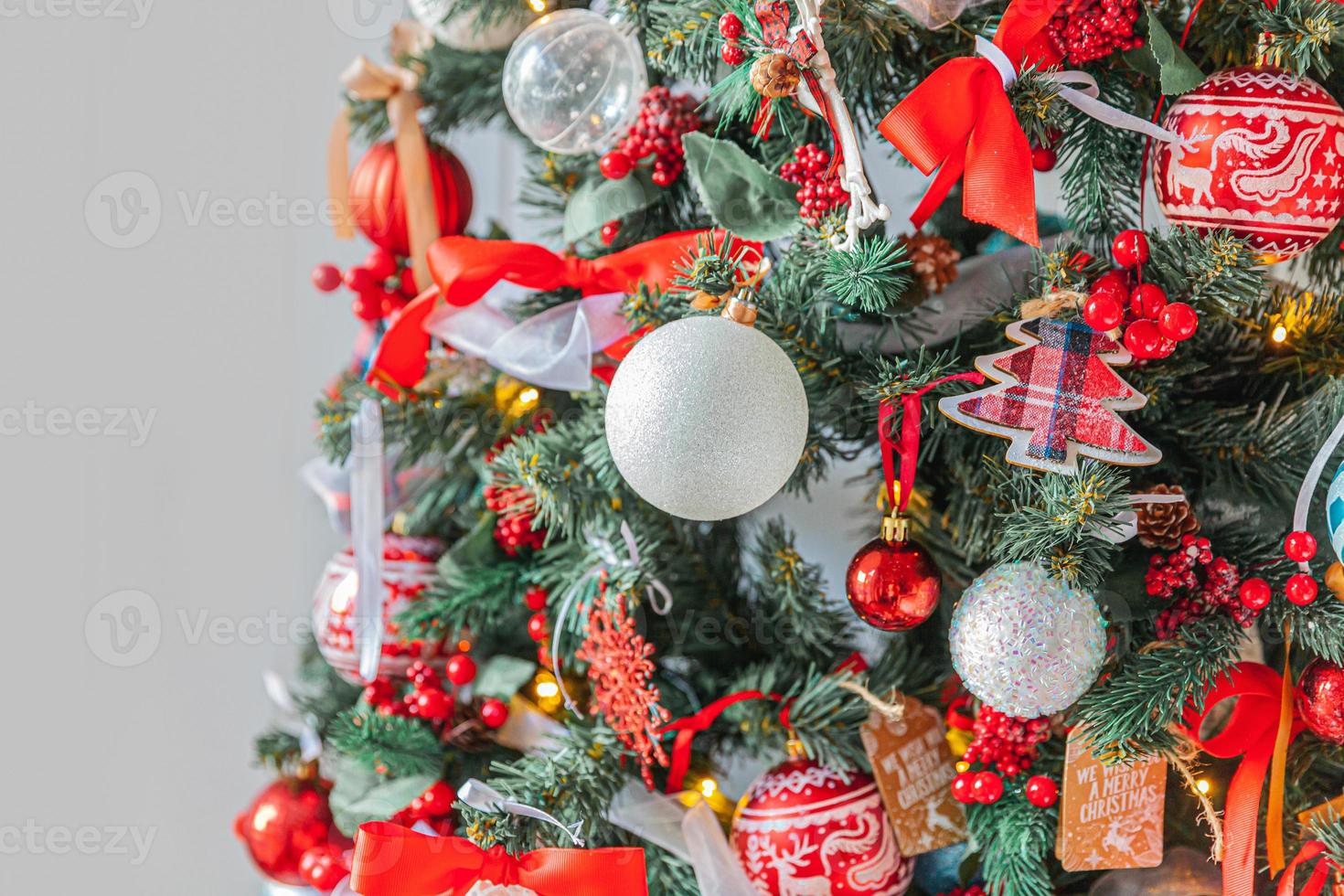 Classic Christmas New Year decorated New year tree with red and white ornament decorations toy and ball. Modern classical style interior design apartment. Christmas eve at home. photo
