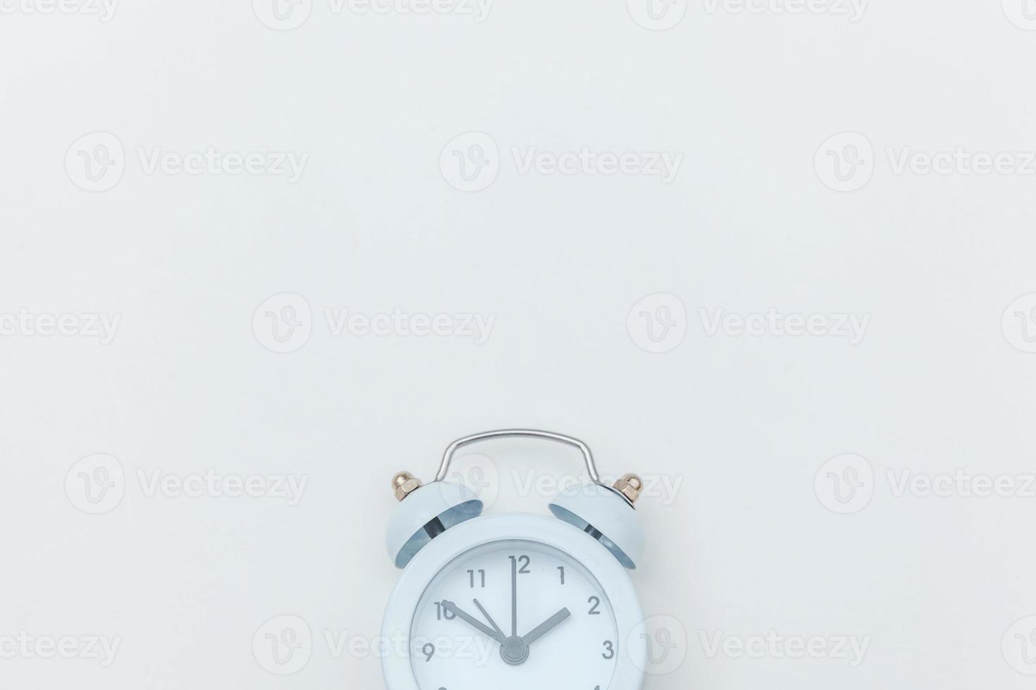 Simply flat lay design Ringing twin bell vintage classic alarm clock Isolated on white background. Rest hours time of life good morning night wake up awake concept. Flat lay top view copy space. photo