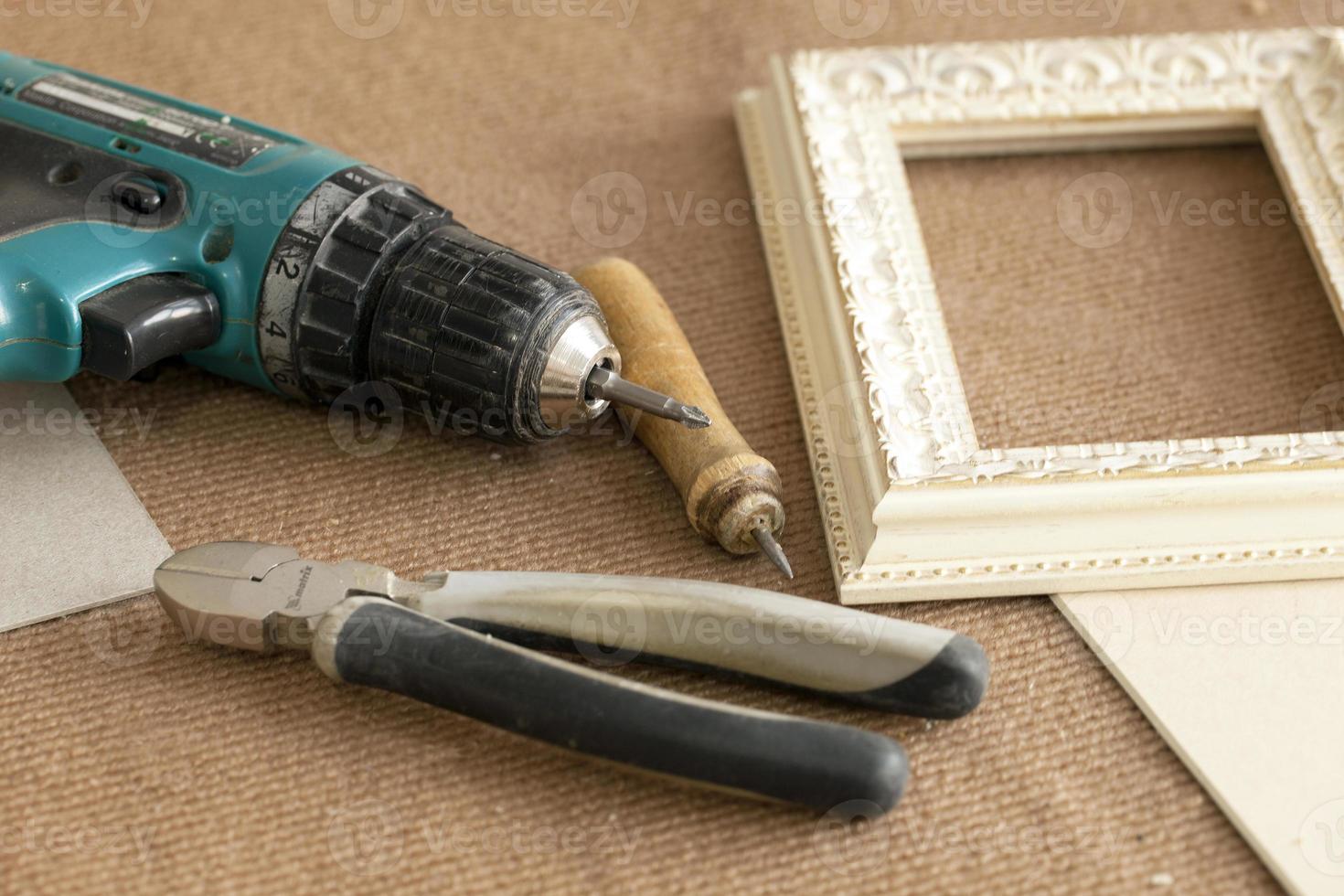 tool Assembly frames, frames, for paintings, photographs, , screwdriver, wire cutters, pliers pencil on beige background photo