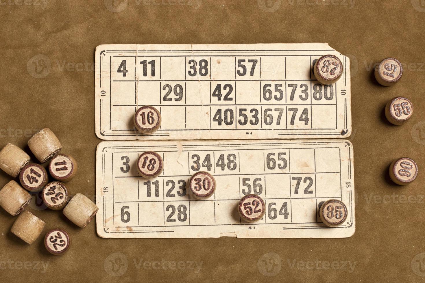 Table game Bingo. Wooden Lotto barrels with bag, playing cards for Lotto card game, leisure, play, strategy, gambling, lottery, photo