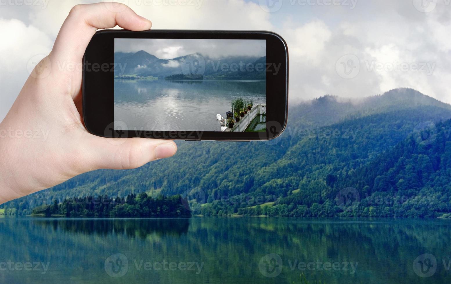 tourist taking photo of Schliersee lake, Bavaria