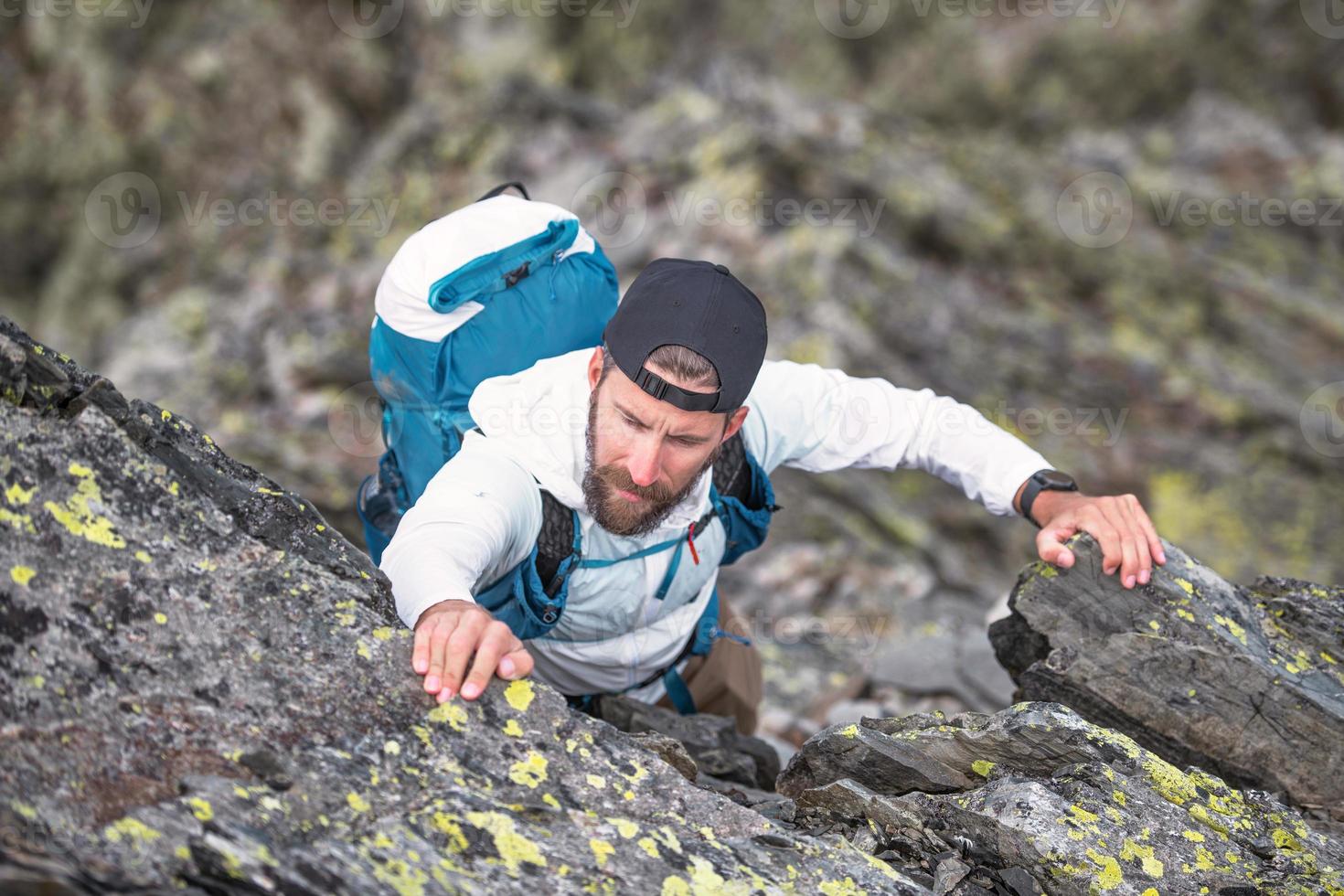 Man during difficult passage in mountain photo