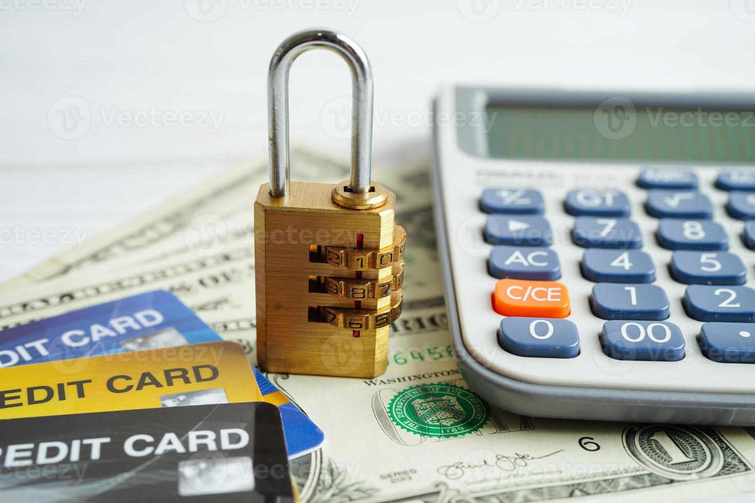 Credit card with password key lock and US dollar banknote money, security finance business concept. photo