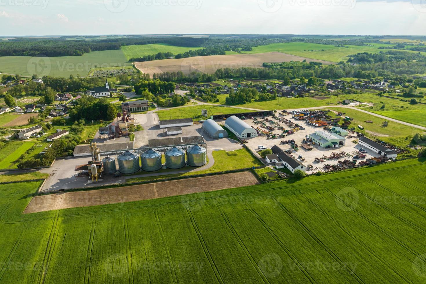 aerial view on agro silos granary elevator with seeds cleaning line on agro-processing manufacturing plant for processing drying cleaning and storage of agricultural products, flour and grain. photo