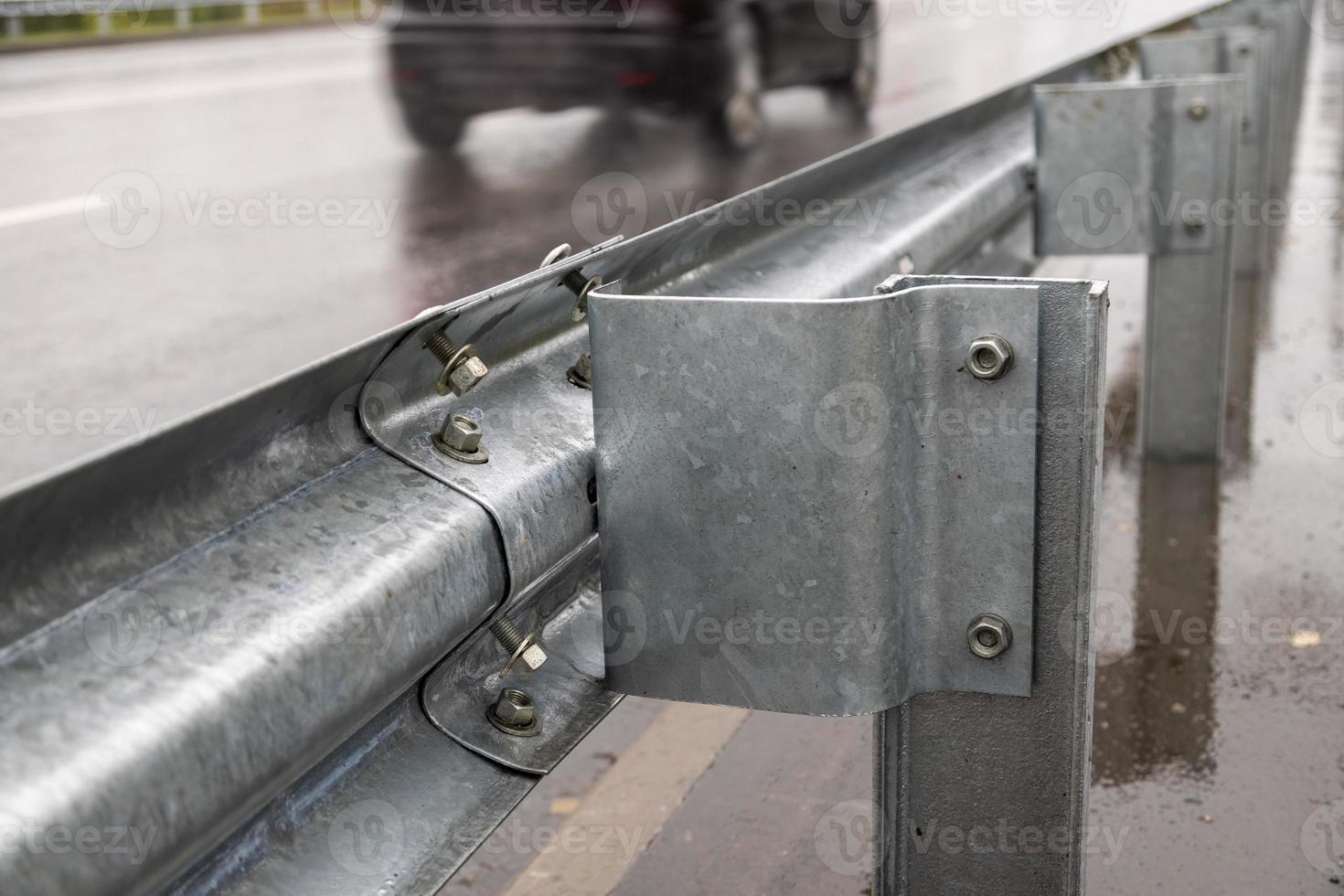 underscrewed nuts and bolts in highway road railing photo