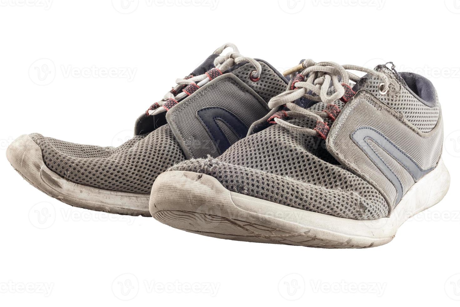 pair of worn out sneakers isolated on white background photo