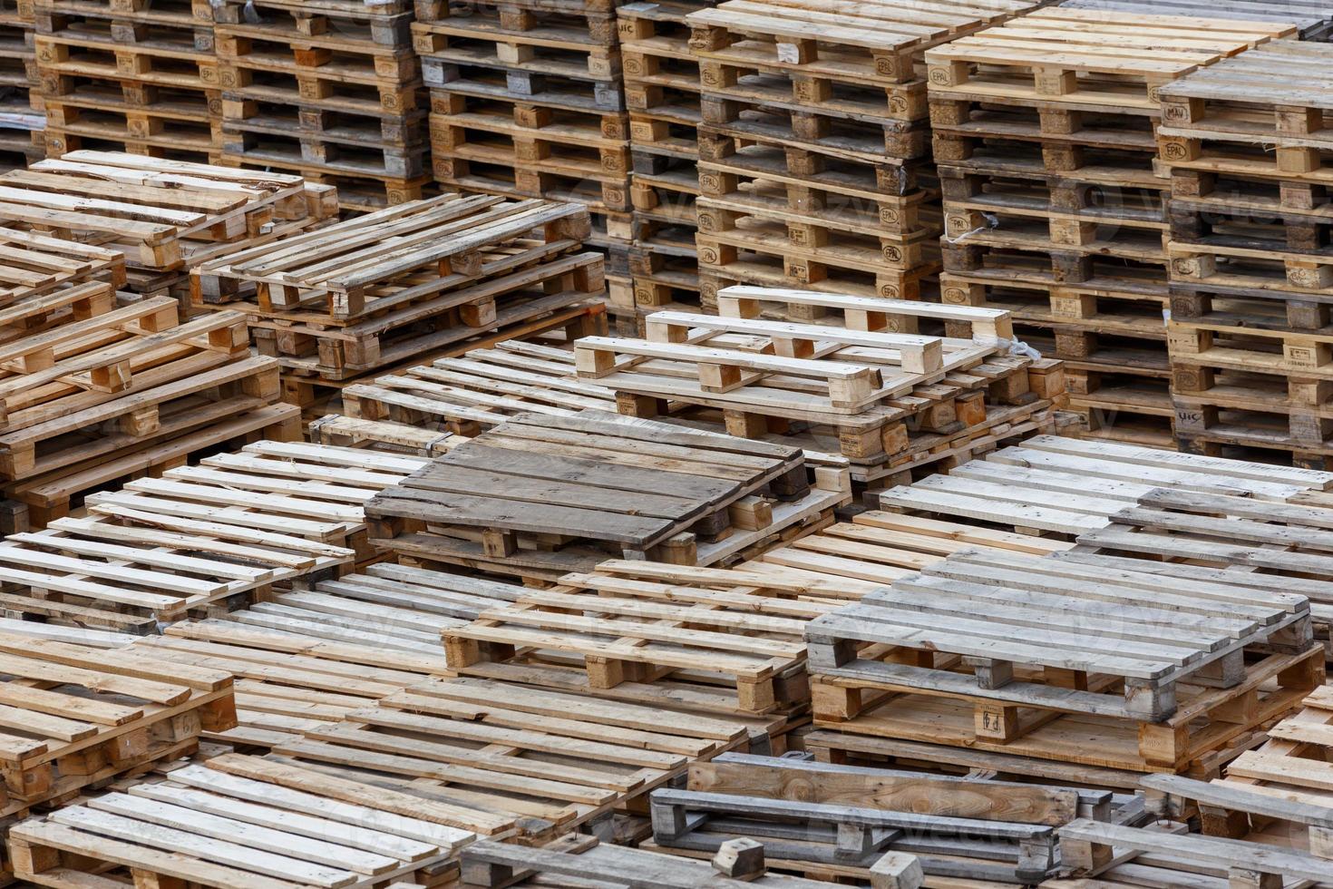 full frame background of used wooden pallet stacks - perspective view from above photo