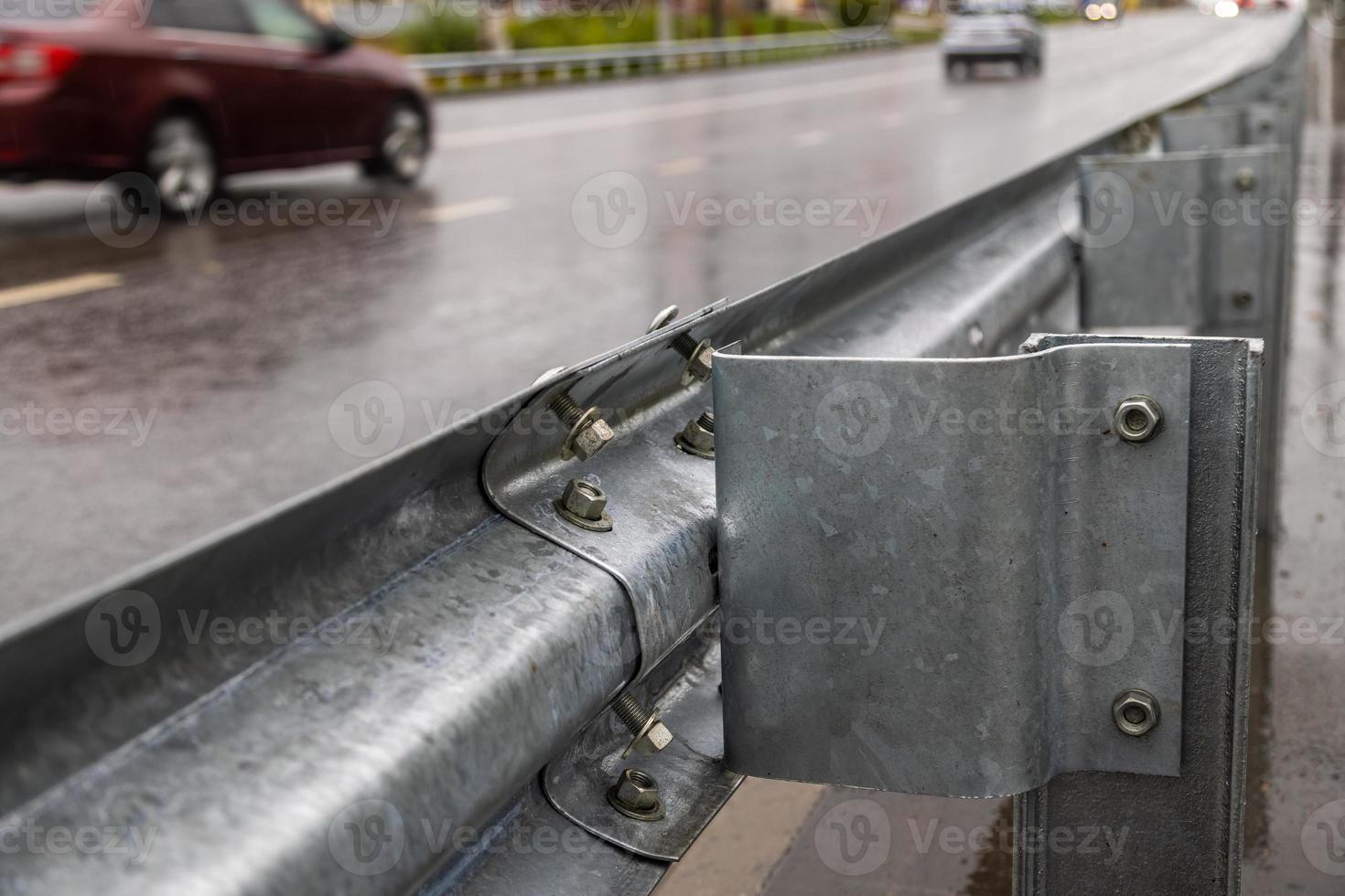 underscrewed nuts and bolts in highway road railing photo