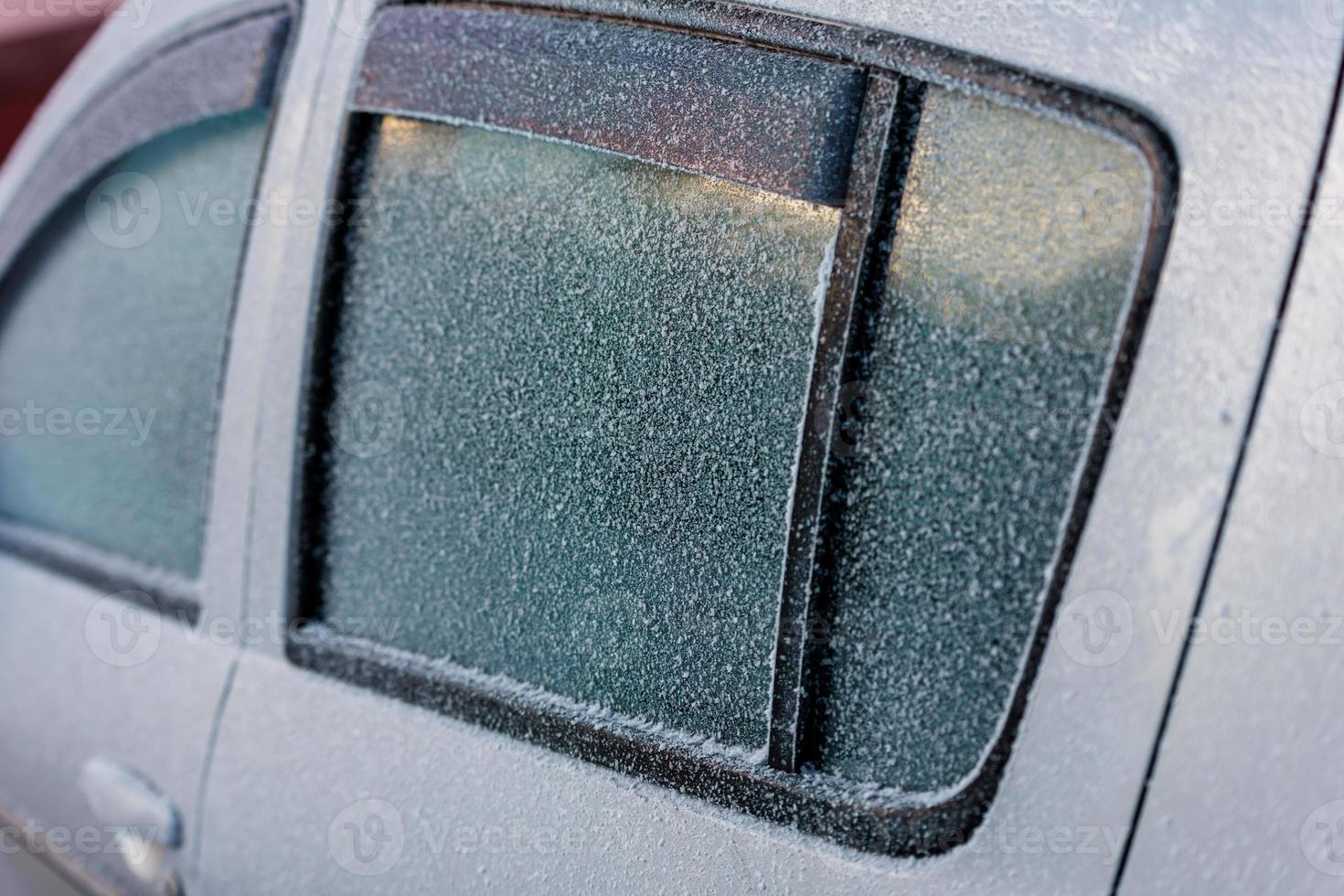 frost covered white car side windows with plastic deflectors - close-up background with selective focus photo