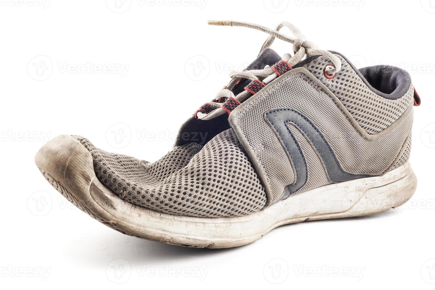 one worn out sneaker isolated on white background photo