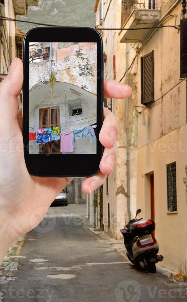 tourist taking photo of side street in town