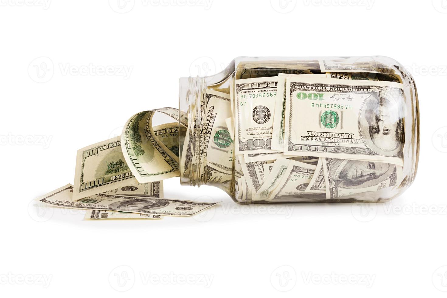 glass jar full of hundred us dollar banknotes laying on side - isolated on white photo