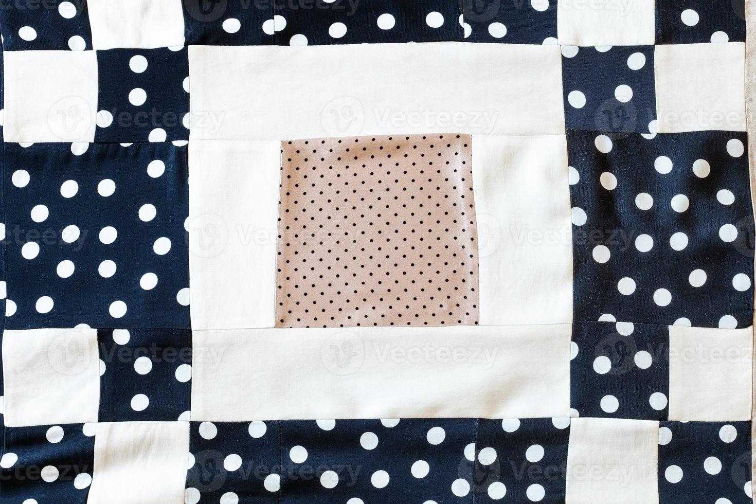 detail of patchwork scarf from polka dots fabrics photo