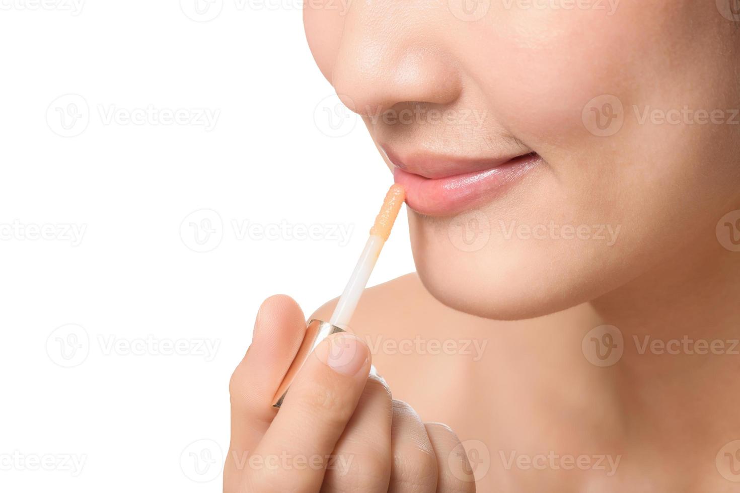 Portrait young asian woman looking mirror applying makeup lipstick at room photo