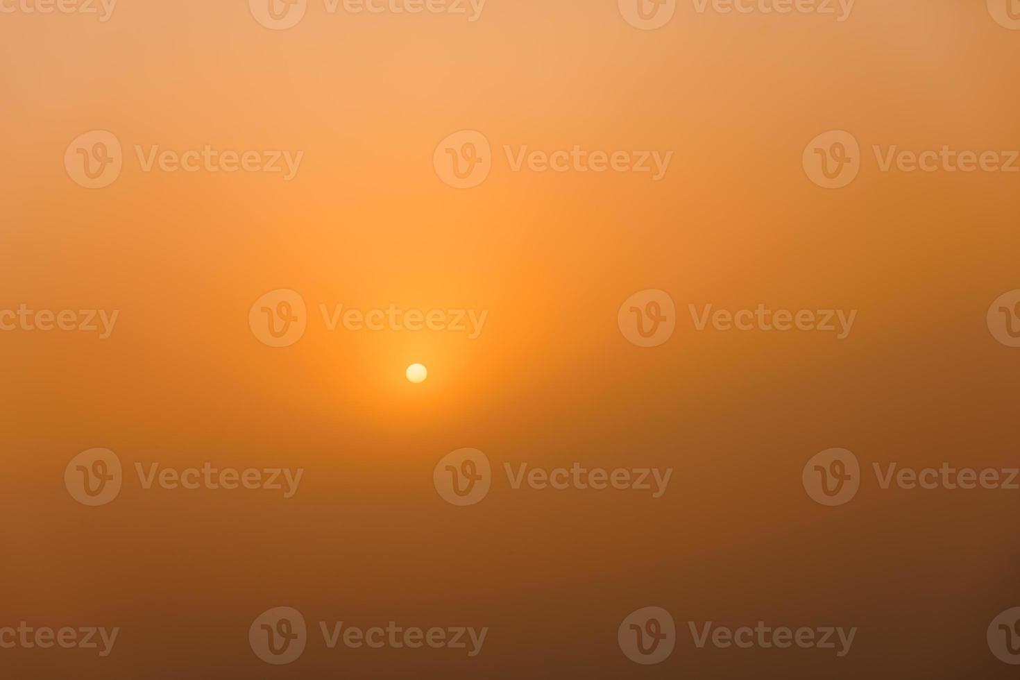 rising sun on clear golden gradient sky without horizon, minimalistic composition photo