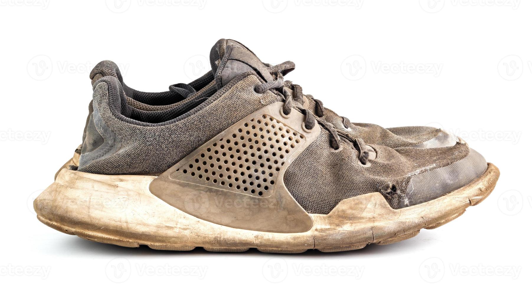 a pair of weared dirty sneakers isolated on white background, side vew photo