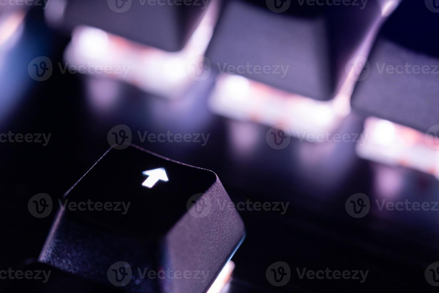 a close-up view of black mechanical pc keyboard with white backlight photo