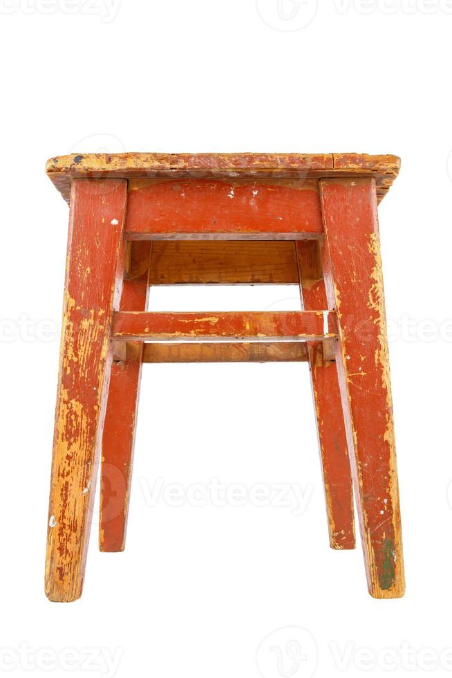 Old wooden stool with brown peeling paint. Loft style chair isolated on a white background. photo