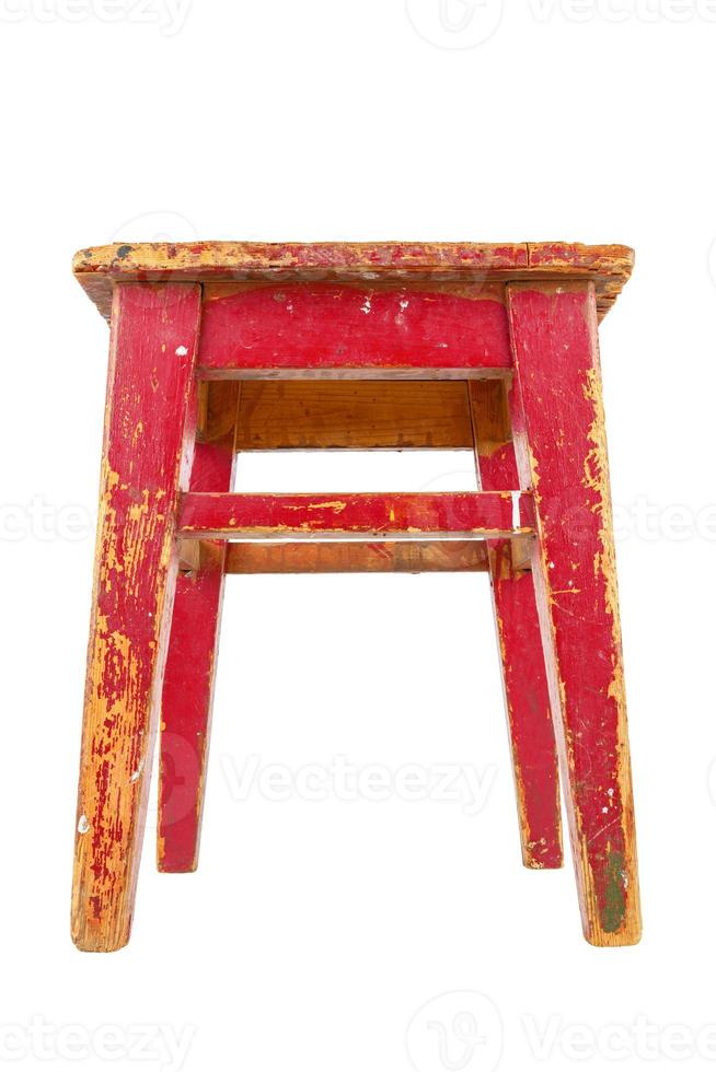 Old wooden stool with peeling red paint. Loft style chair isolated on a white background. photo