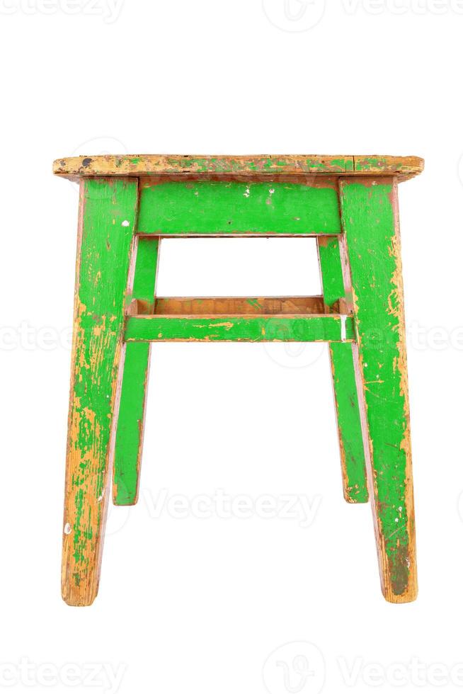 Old wooden stool with green peeling paint. Loft style chair isolated on a white background. photo