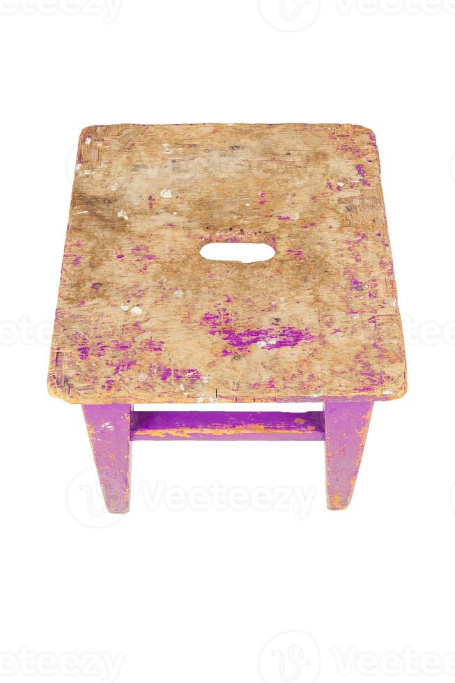 Old wooden stool with peeling pink paint. Loft style chair isolated on a white background. photo