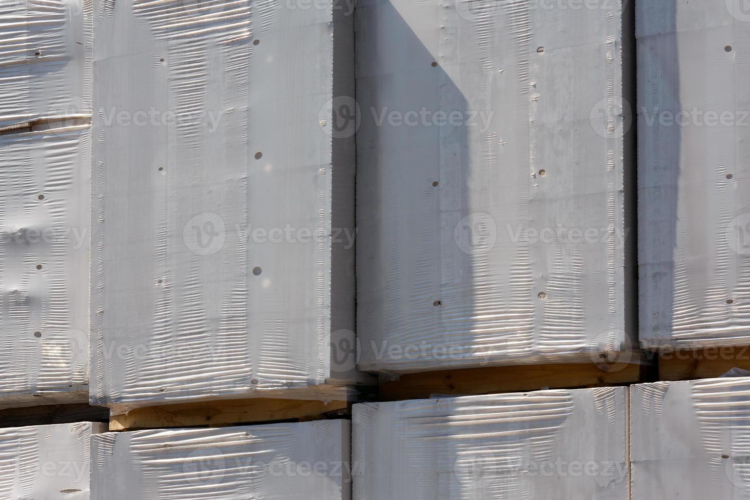 stacked boxes with goods covered with white shrink film photo