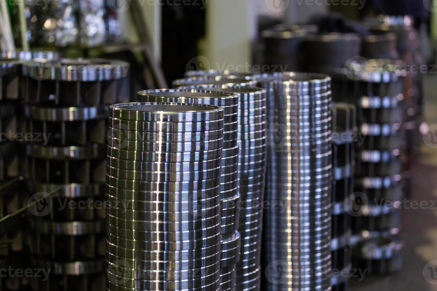 stacks of turned silver colored steel rings after cnc turning operations - close-up with selective focus photo