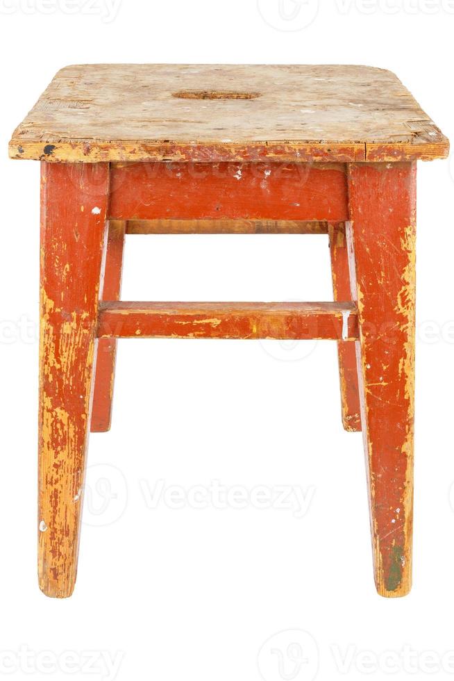 Old wooden stool with brown peeling paint. Loft style chair isolated on white. photo