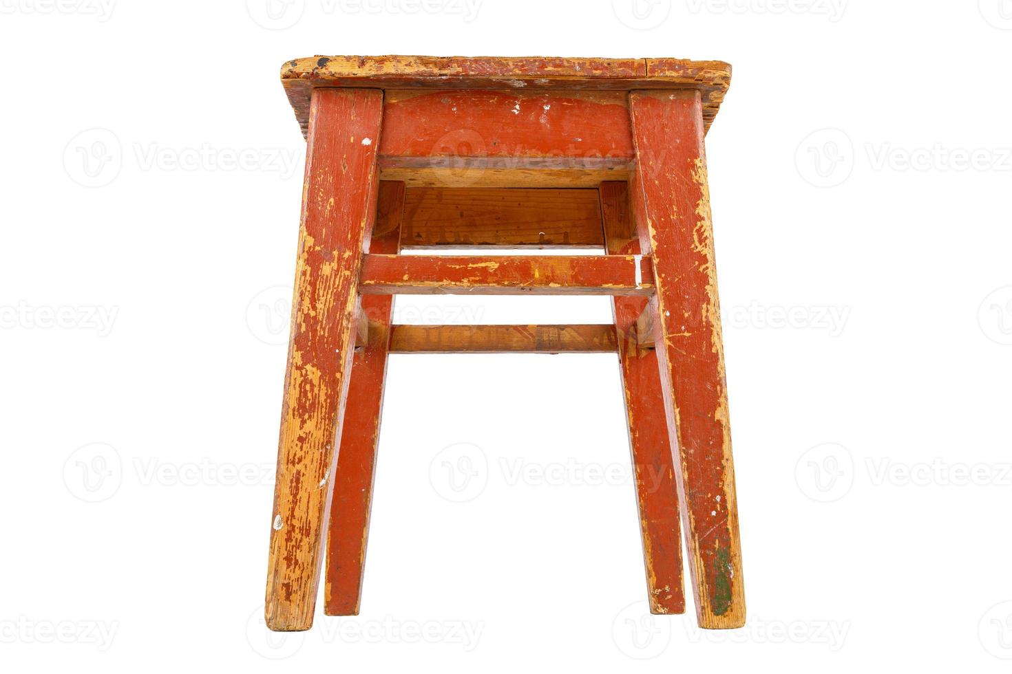 Old wooden stool with brown peeling paint. Loft style chair isolated on white. photo