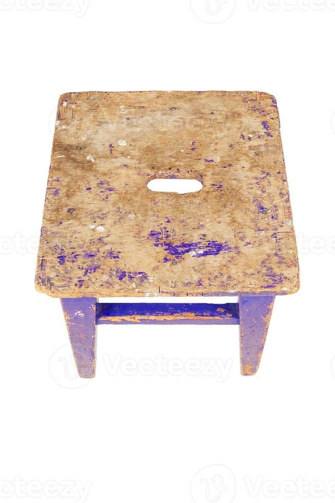 Old wooden stool with peeling blue paint. Loft style chair isolated on a white background. photo