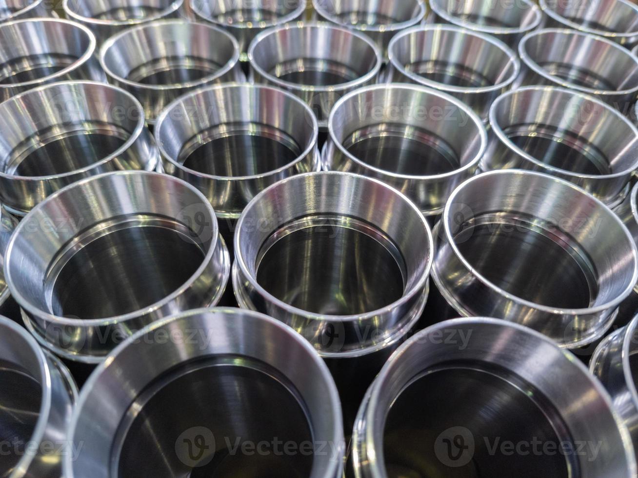 dark industrial background with cnc machined shiny steel pipes - selective focus and lens blur tech photo