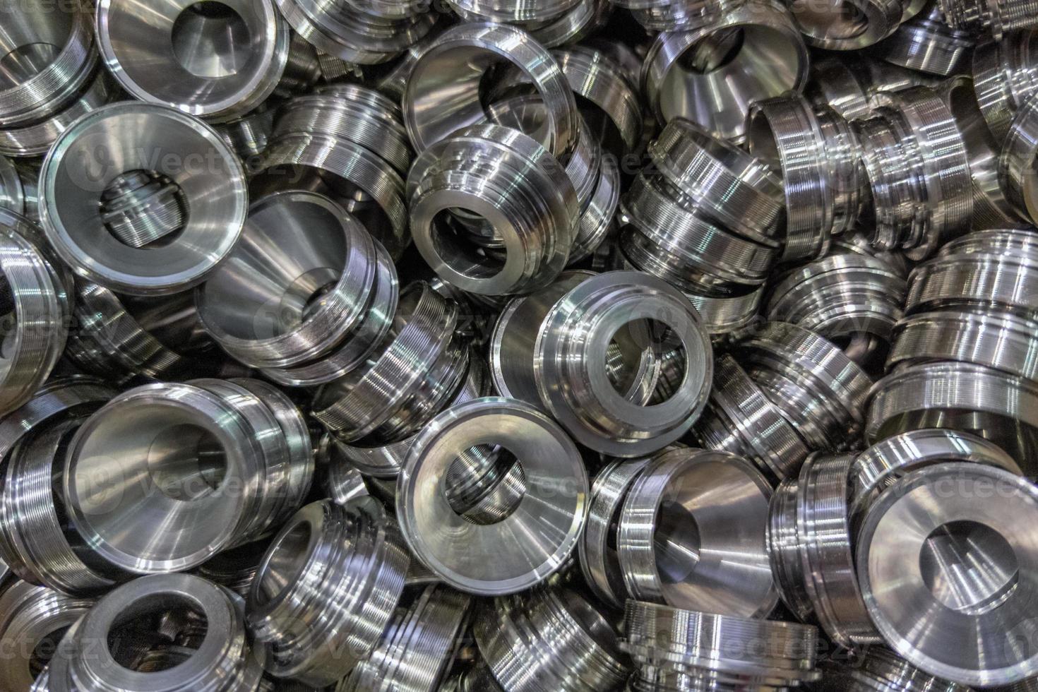 pile of shiny metal aerospace parts production - close-up with selective focus for full frame industrial background photo