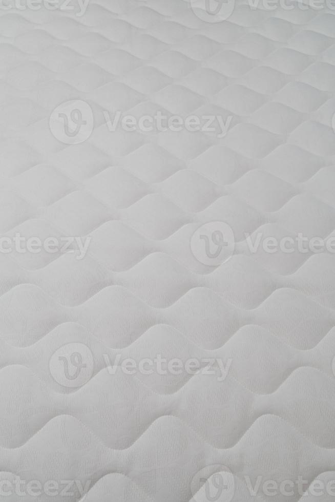 Soft white mattress close-up background with selective focus. photo