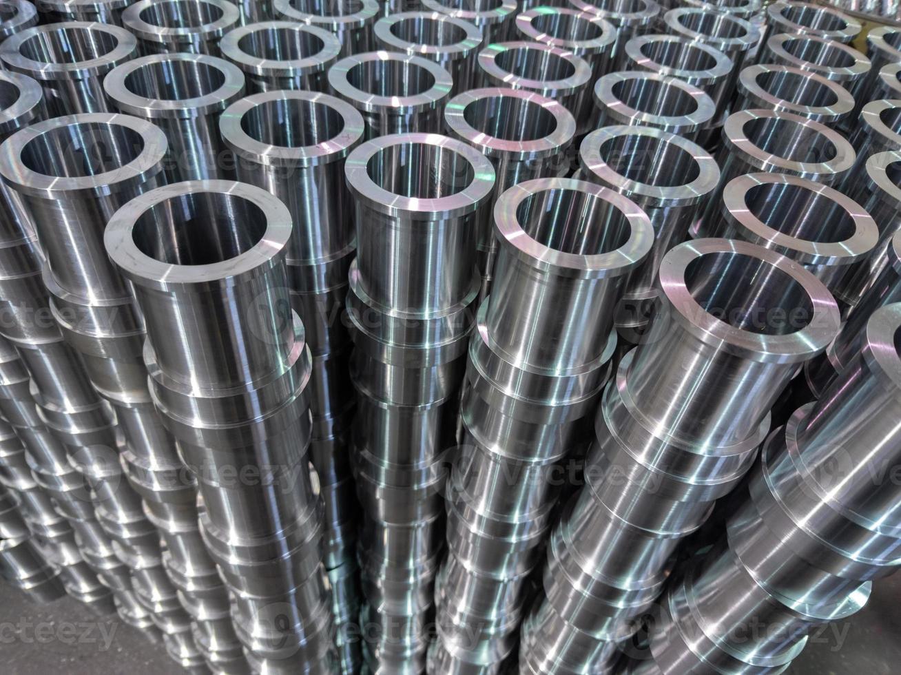 industrial shiny steel production stack background with cnc machined pipes photo