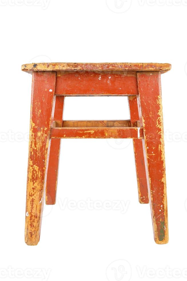 Old wooden stool with brown peeling paint. Loft style chair isolated on a white background. photo