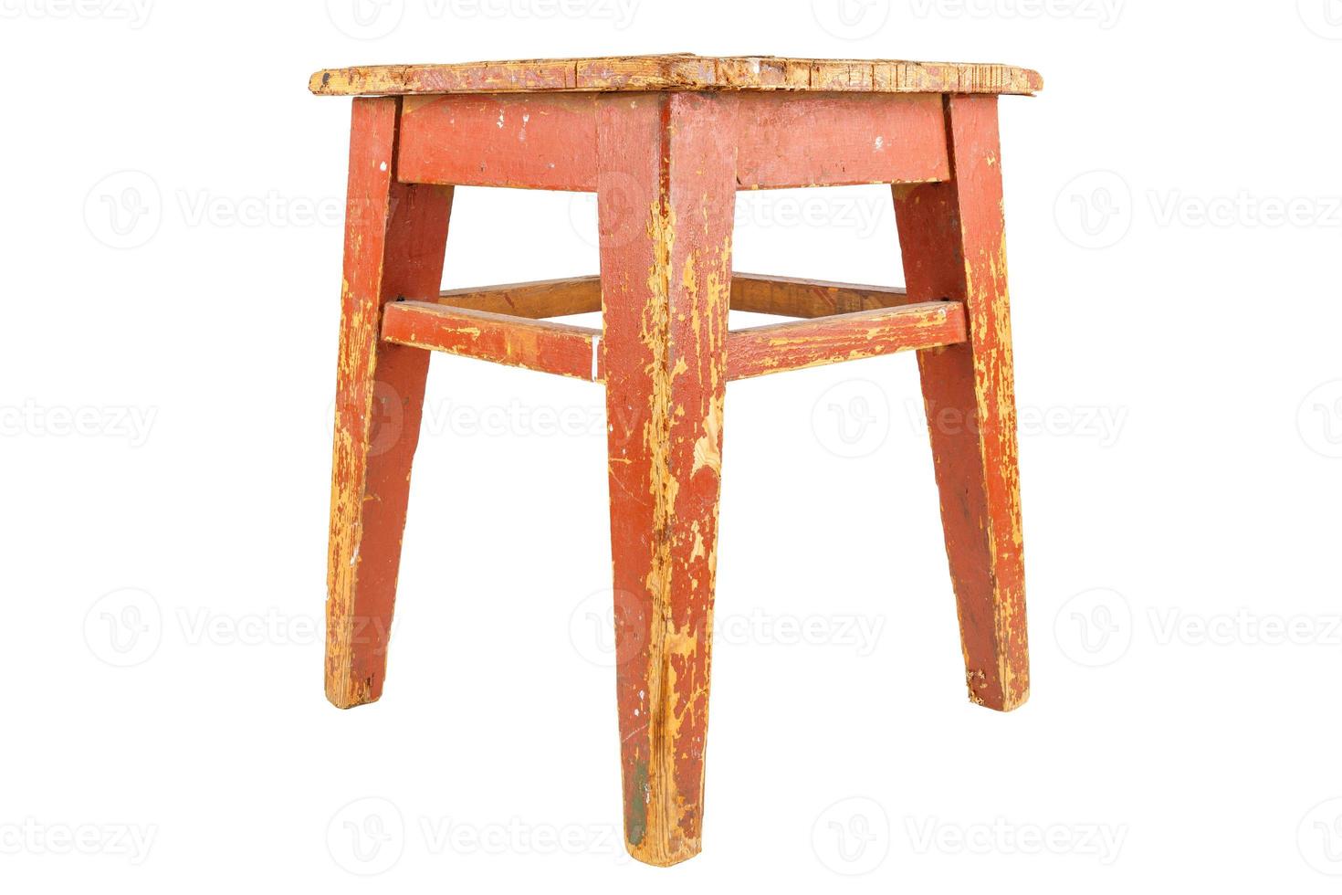 Old wooden stool with brown peeling paint. Loft style chair isolated on white. photo