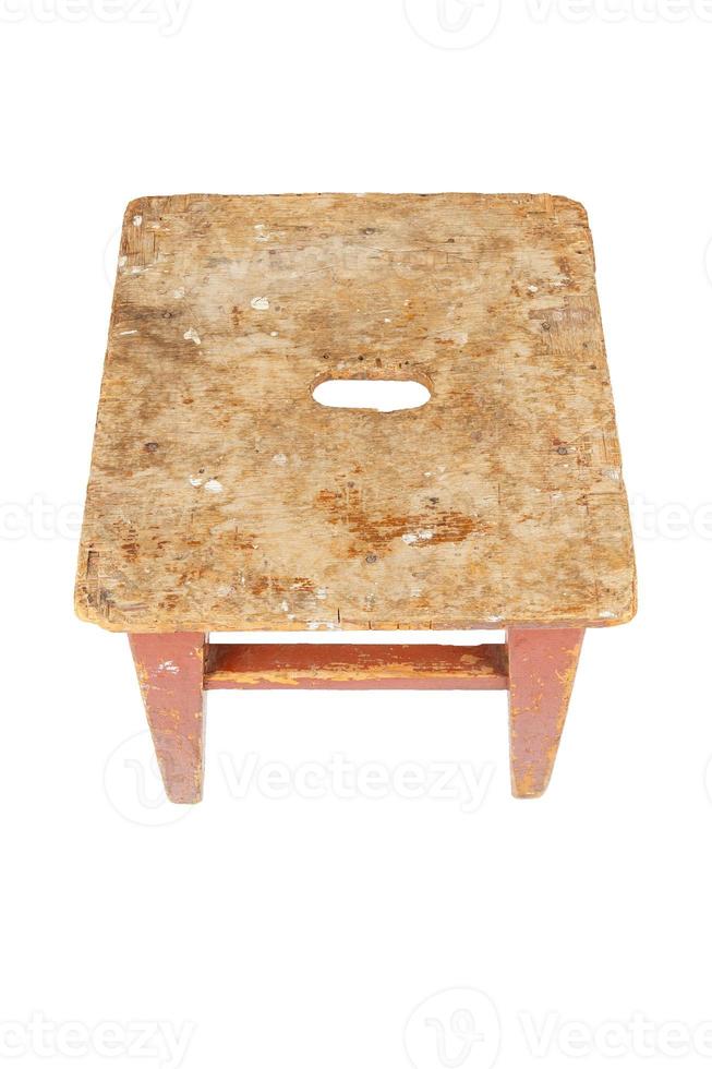 Old wooden stool with peeling brown paint. Loft style chair isolated on a white background. photo