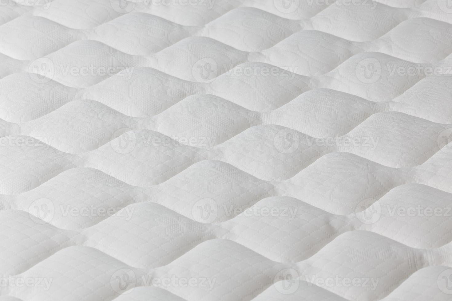 Soft white mattress close-up background with selective focus. photo