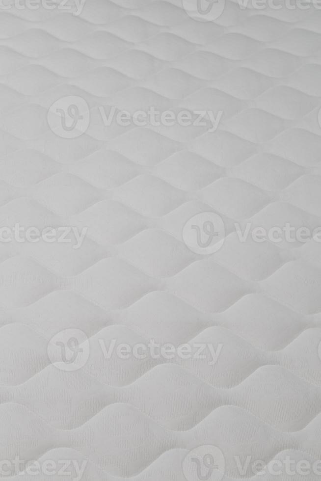 Soft white mattress close-up background with selective focus. photo