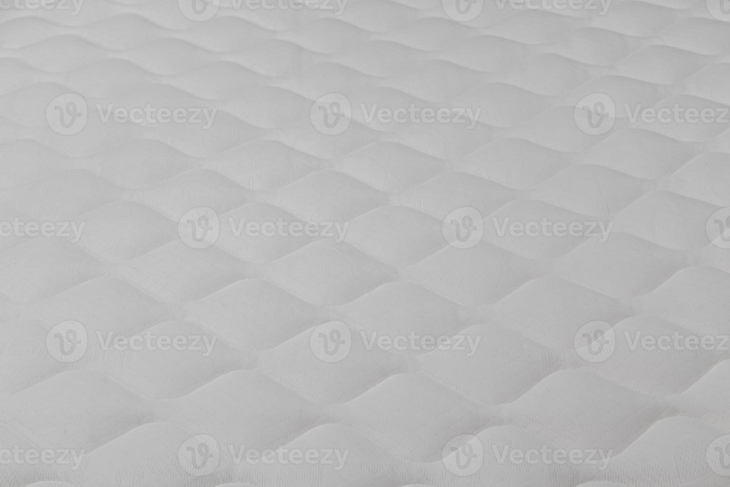 Soft white mattress close-up background with selective focus. photo
