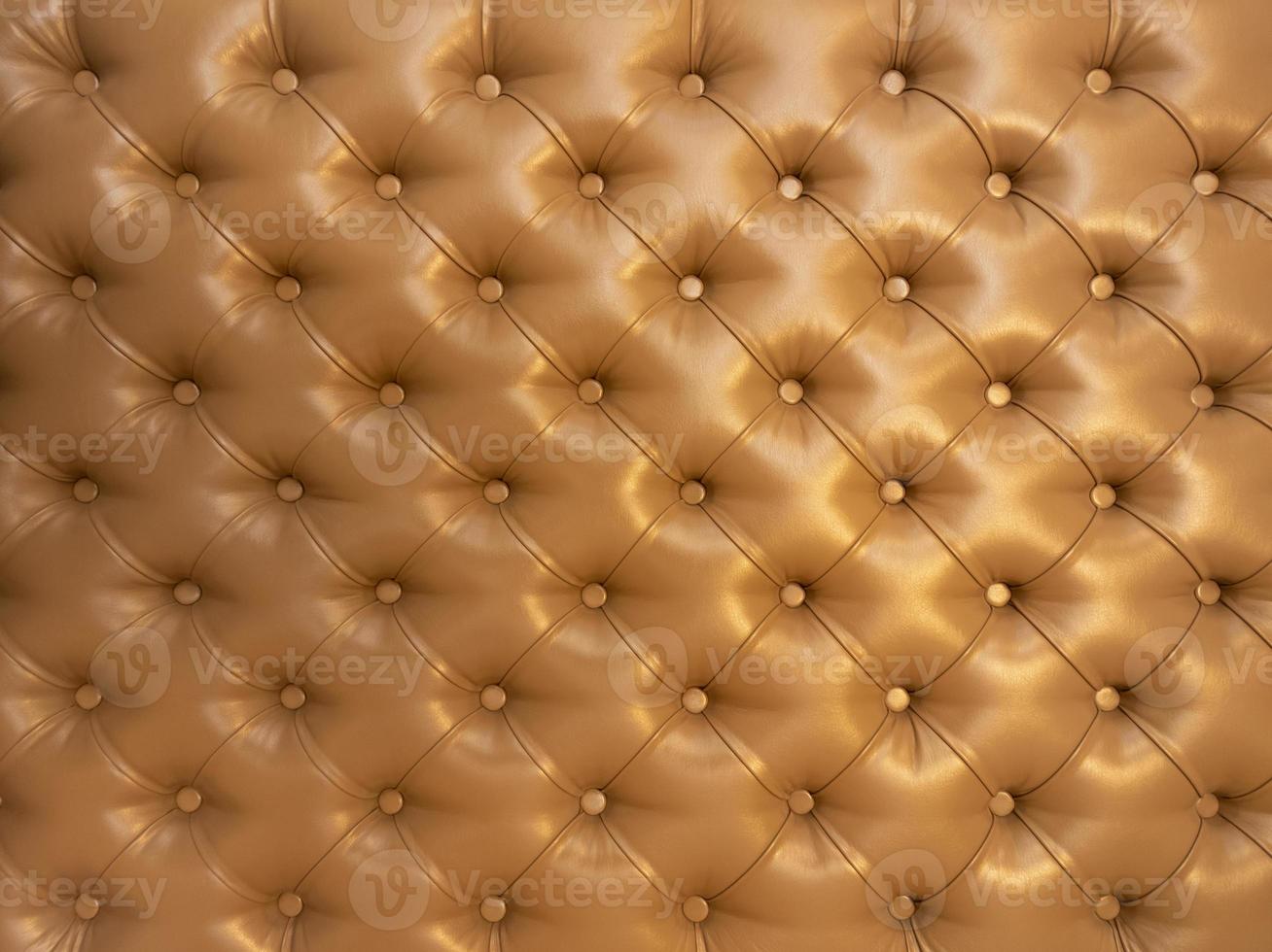Texture of brown beige leather background with capitone pattern, full-frame. Brown retro Chesterfield style. photo