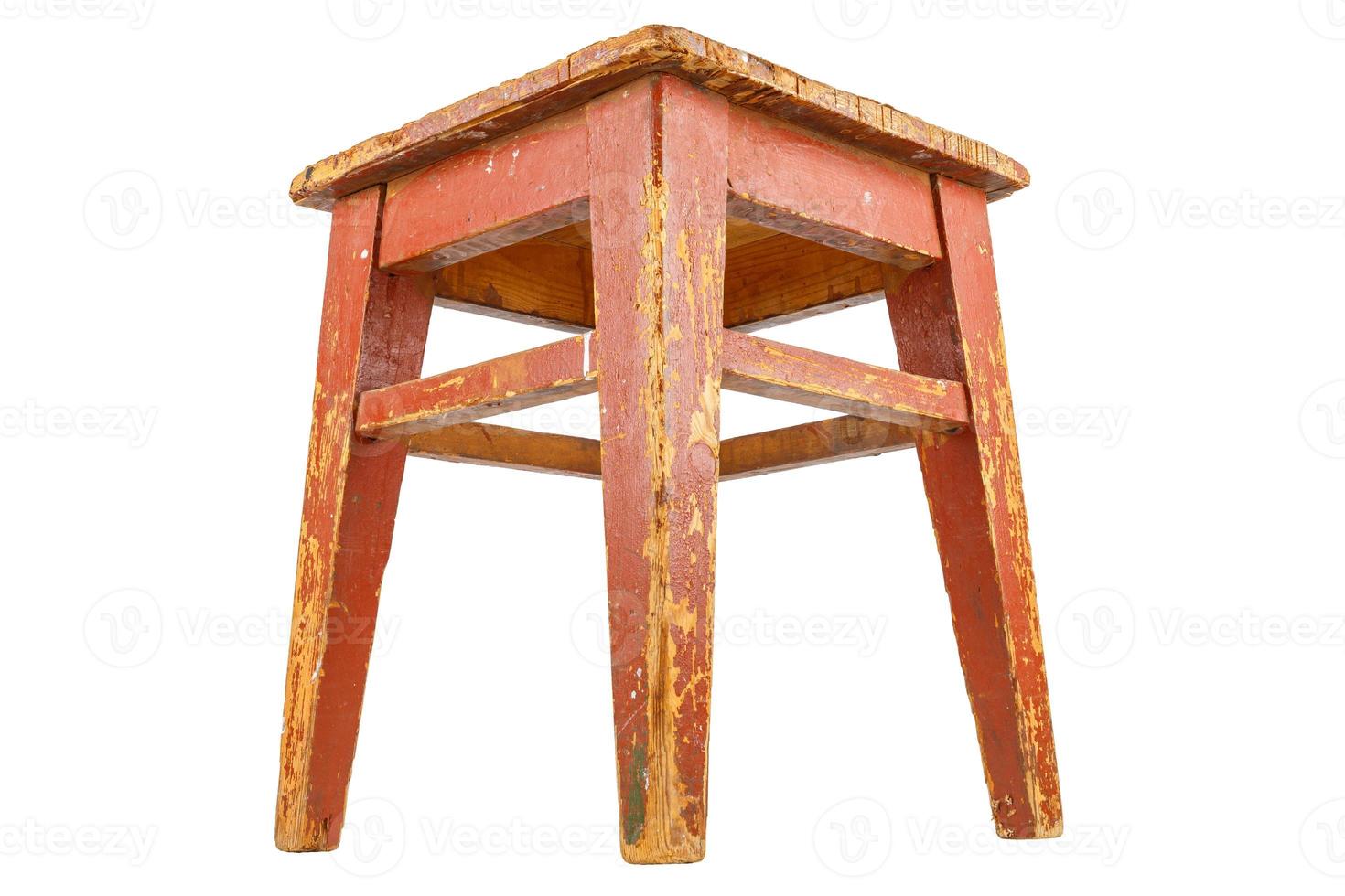 Old wooden stool with brown peeling paint. Loft style chair isolated on white. photo